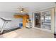 Sunroom featuring a treadmill, ceiling fan and view into the primary bedroom at 6518 Leeside Isle, Hudson, FL 34667