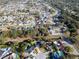 Aerial view of a neighborhood house, pool, mature trees, and green lawns at 7115 Edenwood Pl, Tampa, FL 33615