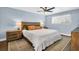 Comfortable bedroom featuring wood furniture, a ceiling fan, neutral paint, and a queen size bed at 7115 Edenwood Pl, Tampa, FL 33615