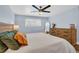 Bedroom featuring natural lighting, a queen-sized bed, and a wooden dresser at 7115 Edenwood Pl, Tampa, FL 33615