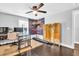 Bedroom with dark wood floors, a faux ivy backdrop and large window at 7115 Edenwood Pl, Tampa, FL 33615