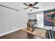 A bedroom featuring dark wood floors, a window with blinds, and a large area rug at 7115 Edenwood Pl, Tampa, FL 33615