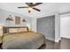 Comfortable bedroom featuring a queen bed, ceiling fan, closet space, and neutral gray wall paint at 7115 Edenwood Pl, Tampa, FL 33615