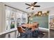 Inviting dining room with natural light, a modern table set, and stylish green paneled accent wall at 7115 Edenwood Pl, Tampa, FL 33615