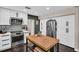 Charming kitchen featuring stainless steel appliances, a butcher block island, and an abundance of storage space at 7115 Edenwood Pl, Tampa, FL 33615