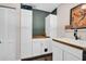 Functional laundry area featuring a utility sink with butcher block countertop, and ample storage space at 7115 Edenwood Pl, Tampa, FL 33615