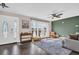 Bright living room with large windows and hardwood floors at 7115 Edenwood Pl, Tampa, FL 33615