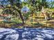 Outdoor basketball court surrounded by mature trees, perfect for recreation and staying active in the community at 712 1St Ct, Palm Harbor, FL 34684