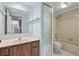 Cozy bathroom featuring a vanity with wood cabinets, and a shower and tub combo at 712 1St Ct, Palm Harbor, FL 34684