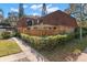 Charming townhome featuring a fenced front yard and a cozy pergola, perfect for outdoor relaxation and privacy at 712 1St Ct, Palm Harbor, FL 34684