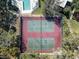 Aerial view of the two community tennis courts, surrounded by lush greenery and mature trees at 712 1St Ct, Palm Harbor, FL 34684