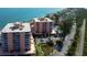 Aerial view of condo buildings with waterfront views and lush landscaping at 7432 Sunshine Skyway S Ln # 206, St Petersburg, FL 33711