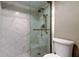 Bright bathroom featuring a walk-in shower with glass enclosure, toilet, and well lit vanity at 7432 Sunshine Skyway S Ln # 206, St Petersburg, FL 33711