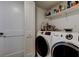 Convenient laundry room with a modern washer and dryer and ample storage space at 7432 Sunshine Skyway S Ln # 206, St Petersburg, FL 33711