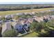 An aerial view of rooftops surrounded by grassy areas, trees, and power lines at 7945 Carriage Pointe Dr, Gibsonton, FL 33534