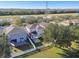 An aerial view of a home in a residential area with trees and power lines visible at 7945 Carriage Pointe Dr, Gibsonton, FL 33534