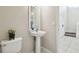 Powder room features a pedestal sink, toilet, and neutral wall paint at 7945 Carriage Pointe Dr, Gibsonton, FL 33534