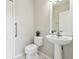 Neutral powder room with a pedestal sink and standard toilet at 7945 Carriage Pointe Dr, Gibsonton, FL 33534