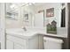 Bright bathroom features a white vanity with a decorative mirror and stylish artwork at 7945 Carriage Pointe Dr, Gibsonton, FL 33534