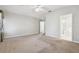 Large bedroom with neutral carpet and ample natural light, adjacent to the bathroom at 7945 Carriage Pointe Dr, Gibsonton, FL 33534