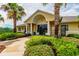 Inviting clubhouse entrance with pillars and well-maintained landscaping at 7945 Carriage Pointe Dr, Gibsonton, FL 33534