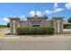 Elegant community entrance sign with stone accents and lush landscaping at 7945 Carriage Pointe Dr, Gibsonton, FL 33534