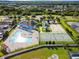 Aerial view of a community pool and recreation area with tennis and basketball courts at 7945 Carriage Pointe Dr, Gibsonton, FL 33534