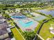 Aerial view of a community pool and recreation area with tennis and basketball courts at 7945 Carriage Pointe Dr, Gibsonton, FL 33534