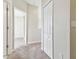 Hallway features neutral carpet and white doors, creating a clean and open feel at 7945 Carriage Pointe Dr, Gibsonton, FL 33534