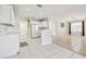 Bright kitchen featuring white appliances, white cabinets, and an open layout at 7945 Carriage Pointe Dr, Gibsonton, FL 33534