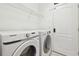 Clean laundry room featuring modern washer and dryer with white walls at 7945 Carriage Pointe Dr, Gibsonton, FL 33534