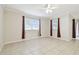 Bright living room with tile floors, ample natural light, and a ceiling fan, perfect for relaxing at 7945 Carriage Pointe Dr, Gibsonton, FL 33534