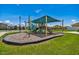 Community playground with slide and green canopy at 7945 Carriage Pointe Dr, Gibsonton, FL 33534