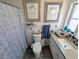 This bathroom features a shower-tub combo, single sink vanity, and natural light from a window at 8445 Jeffrey N # 8445, Pinellas Park, FL 33781