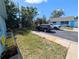 Exterior shot of blue home, black SUV, and white truck parked in the driveway at 8445 Jeffrey N # 8445, Pinellas Park, FL 33781