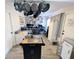 Wide shot showcasing the kitchen island, hanging cookware, and adjacent living space at 8445 Jeffrey N # 8445, Pinellas Park, FL 33781