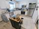 Efficient kitchen features stainless steel appliances, white cabinets, and gray countertops at 8445 Jeffrey N # 8445, Pinellas Park, FL 33781