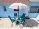 View of patio featuring outdoor seating under an umbrella with a red-tiled roof home at 8445 Jeffrey N # 8445, Pinellas Park, FL 33781