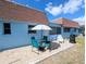 View of patio featuring outdoor seating under an umbrella with a red-tiled roof home at 8445 Jeffrey N # 8445, Pinellas Park, FL 33781