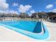 Community pool view featuring refreshing clear blue water and surrounding lounge chairs at 8445 Jeffrey N # 8445, Pinellas Park, FL 33781