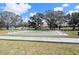 Shuffleboard courts surrounded by green grass and mature trees on a sunny day at 8445 Jeffrey N # 8445, Pinellas Park, FL 33781