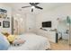 Bright bedroom featuring a ceiling fan, television, dresser, and mirror, creating a comfortable retreat at 8990 Forge Breeze Loop, Wesley Chapel, FL 33545