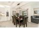 Cozy dining area with an elegant chandelier, table seating six, and modern decor at 8990 Forge Breeze Loop, Wesley Chapel, FL 33545