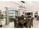 Open dining space with a sliding glass door that allows for light and view of backyard at 8990 Forge Breeze Loop, Wesley Chapel, FL 33545