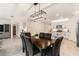 Elegant dining space with view into kitchen and with modern lighting at 8990 Forge Breeze Loop, Wesley Chapel, FL 33545