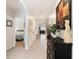 Inviting hallway with art display, leading to bedrooms and living areas, with decorative accents at 8990 Forge Breeze Loop, Wesley Chapel, FL 33545