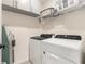 Efficient laundry area with modern appliances and ample storage, making chores convenient and organized at 8990 Forge Breeze Loop, Wesley Chapel, FL 33545