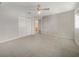 Spacious bedroom with neutral carpet, ceiling fan and double door closet at 9003 Willowbrook Cir, Bradenton, FL 34212