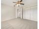 Upstairs bedroom with neutral carpet, ceiling fan and double door closet at 9003 Willowbrook Cir, Bradenton, FL 34212