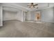 Primary bedroom with neutral carpet, ceiling fan and access to ensuite bathroom at 9003 Willowbrook Cir, Bradenton, FL 34212